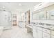 Bright bathroom features dual sinks, marble countertops, a shower, and a closet at 3821 W Vasconia St, Tampa, FL 33629
