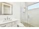 Modern bathroom featuring a glass shower and a vanity with a mirror at 3821 W Vasconia St, Tampa, FL 33629