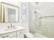 Modern bathroom featuring a glass-enclosed shower, white subway tile, and marble vanity at 3821 W Vasconia St, Tampa, FL 33629