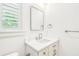 Modern half bathroom featuring a marble vanity, and luxury fixtures at 3821 W Vasconia St, Tampa, FL 33629