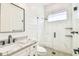 Bathroom features a white herringbone tiled shower, marble countertops, and black fixtures at 3821 W Vasconia St, Tampa, FL 33629