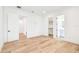 Bright bedroom with light hardwood floors, multiple closets, and ensuite bathrooms at 3821 W Vasconia St, Tampa, FL 33629