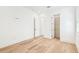 Bright bedroom features hardwood floors, a neutral palette, and a closet for ample storage at 3821 W Vasconia St, Tampa, FL 33629