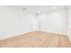 Bright bedroom with light hardwood floors, and plantation shutters at 3821 W Vasconia St, Tampa, FL 33629