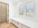 Bedroom featuring hardwood floors, a built in bench below the window, and a walk-in closet at 3821 W Vasconia St, Tampa, FL 33629