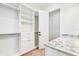 Custom walk-in closet with built-in shelving, drawers, and marble countertop, offering ample storage space at 3821 W Vasconia St, Tampa, FL 33629