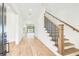 Light filled entryway with hardwood floors and wrought iron staircase at 3821 W Vasconia St, Tampa, FL 33629