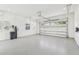 Clean and bright garage with white walls, speckled floor and an insulated garage door at 3821 W Vasconia St, Tampa, FL 33629