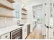 Hallway featuring a sink with wood floating shelves and a wine refrigerator at 3821 W Vasconia St, Tampa, FL 33629