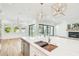 The bright, open kitchen features a large center island, stainless steel appliances, and views of the fireplace at 3821 W Vasconia St, Tampa, FL 33629
