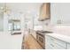 A chef's kitchen features an island with quartz countertops, high-end appliances, and custom cabinetry at 3821 W Vasconia St, Tampa, FL 33629