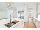 Bright kitchen with a center island that includes a sink, stainless steel appliances, and wood floors at 3821 W Vasconia St, Tampa, FL 33629