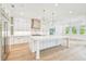 A spacious kitchen with stainless steel appliances and a central island with seating and wooden floors at 3821 W Vasconia St, Tampa, FL 33629