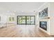 Open concept living room with fireplace and sliding glass doors to the pool area at 3821 W Vasconia St, Tampa, FL 33629