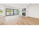 Bright living room with a fireplace and glass doors leading to the pool at 3821 W Vasconia St, Tampa, FL 33629