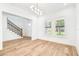 Bright living room featuring hardwood floors, staircase, and shuttered windows at 3821 W Vasconia St, Tampa, FL 33629