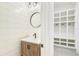 Powder room with wood vanity and mirror next to built-in cubbies at 3821 W Vasconia St, Tampa, FL 33629