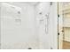 Luxurious walk-in shower featuring dual shower heads, white subway tile, and built-in niche for toiletries at 3821 W Vasconia St, Tampa, FL 33629