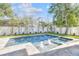 Backyard with a pristine in-ground swimming pool, spa, manicured landscaping, and privacy fencing at 3821 W Vasconia St, Tampa, FL 33629