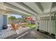 Cozy covered patio with stylish seating area, modern firepit, and an artificial lawn for easy maintenance at 4013 W Waterman Ave, Tampa, FL 33609