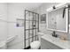 Modern bathroom featuring subway tile, glass shower, updated fixtures, and a vanity mirror at 4013 W Waterman Ave, Tampa, FL 33609
