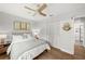 Bright bedroom featuring a closet, a modern ceiling fan and a view to a modern bathroom at 4013 W Waterman Ave, Tampa, FL 33609