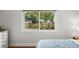 A sunlit bedroom with a large window view and neutral décor at 4013 W Waterman Ave, Tampa, FL 33609