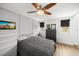 Cozy bedroom with a ceiling fan, dresser, and two windows for natural light at 4013 W Waterman Ave, Tampa, FL 33609