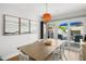 Modern dining room features a rustic table and sliding door to the outdoor entertaining area at 4013 W Waterman Ave, Tampa, FL 33609