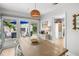Bright dining room with contemporary light fixture and direct access to backyard pool and patio at 4013 W Waterman Ave, Tampa, FL 33609