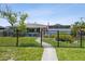 Charming, blue one story house features a tidy front yard, and black metal fence at 4013 W Waterman Ave, Tampa, FL 33609