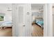 Hallway view of bedrooms featuring ceiling fans and hardwood floors at 4013 W Waterman Ave, Tampa, FL 33609