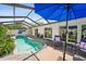 Enclosed pool area with comfortable seating, verdant landscaping, and direct access to the house at 4013 W Waterman Ave, Tampa, FL 33609