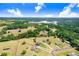 Aerial view highlighting the property's setting amidst expansive countryside with lakes and treelines at 41043 Stanton Hall Dr, Dade City, FL 33525
