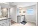 Bright bathroom with double sinks, granite countertops, and ample cabinet space for easy organization at 41043 Stanton Hall Dr, Dade City, FL 33525