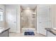 Modern bathroom featuring a glass-enclosed shower, neutral tile, and fixtures for a clean aesthetic at 41043 Stanton Hall Dr, Dade City, FL 33525