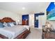 Relax in this bedroom with its luxurious bed, a beautiful accent wall, and plush carpet flooring at 41043 Stanton Hall Dr, Dade City, FL 33525