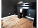 Modern bedroom with dark walls and a unique bunk bed setup with desk space at 41043 Stanton Hall Dr, Dade City, FL 33525