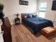 Cozy bedroom with wood-look floors, natural light, and a patriotic theme at 41043 Stanton Hall Dr, Dade City, FL 33525