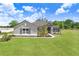 Charming single-story home featuring a lush green lawn and a well-maintained landscape at 41043 Stanton Hall Dr, Dade City, FL 33525