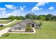 Beautiful single-story home with lush green lawn, elegant landscaping, and a paved walkway leading to the front door at 41043 Stanton Hall Dr, Dade City, FL 33525