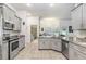 Modern kitchen featuring tile floor, stainless steel appliances, and granite countertops at 41043 Stanton Hall Dr, Dade City, FL 33525