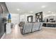 An open concept living area with tile flooring, modern furnishings, and views to the kitchen at 41043 Stanton Hall Dr, Dade City, FL 33525