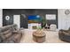 Modern living room boasts tile flooring, fireplace, large sectional, and coastal decor at 41043 Stanton Hall Dr, Dade City, FL 33525