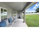 Covered patio offering a relaxing outdoor living space with comfortable seating and open views at 41043 Stanton Hall Dr, Dade City, FL 33525