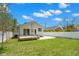Large backyard with grassy lawn, wooden deck, and white privacy fence at 422 24Th N St, St Petersburg, FL 33713