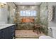 Bathroom boasts a window in the shower, complementing the leafy-themed tile and decor at 422 24Th N St, St Petersburg, FL 33713