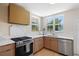 Bright kitchen with marble counters, stainless steel appliances, and natural wood cabinets, offering a modern and functional space at 422 24Th N St, St Petersburg, FL 33713