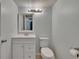 Bathroom featuring a white vanity, mirror, toilet, and neutral-colored walls at 4225 Barret Ave, Plant City, FL 33566