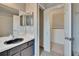 Bathroom vanity with basin sink, mirror, walk-in closet and tiled floor at 4225 Barret Ave, Plant City, FL 33566